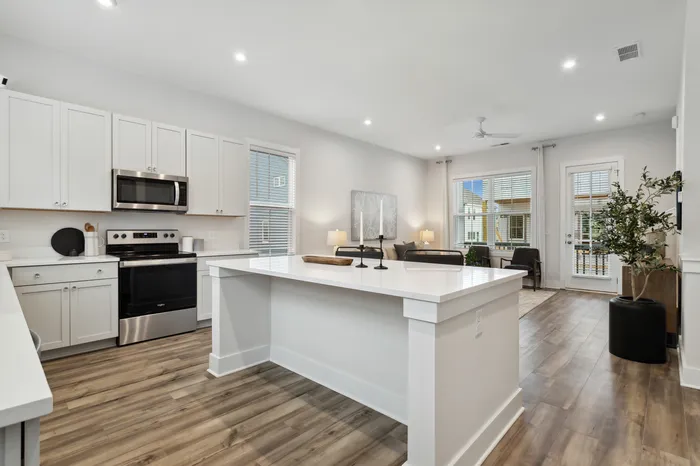 furnished kitchen with island and living area in home