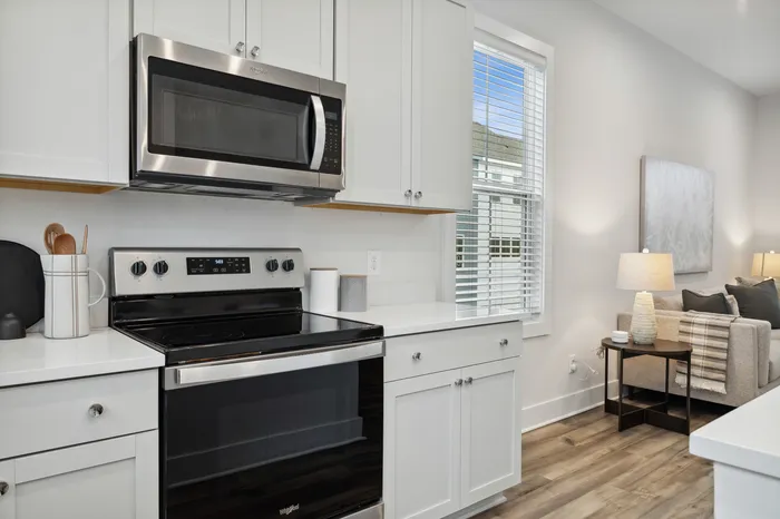 furnished kitchen with stove and microwave in home