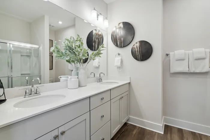 furnished bathroom with double sink vanity in home