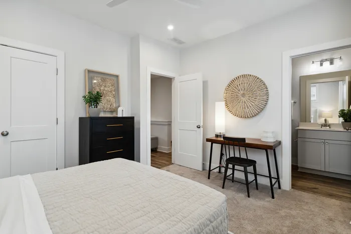 furnished bedroom with bed and desk in home