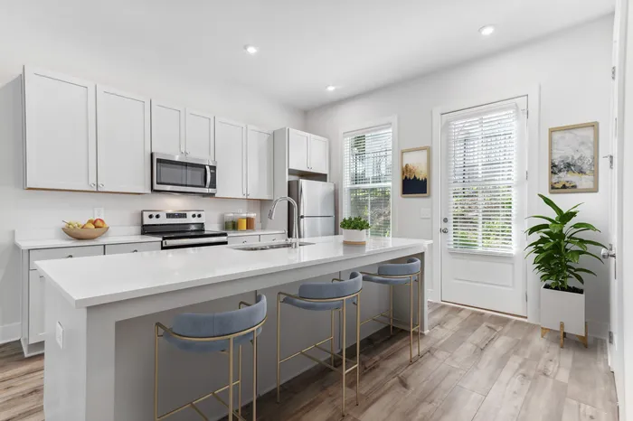 furnished kitchen area with island in home