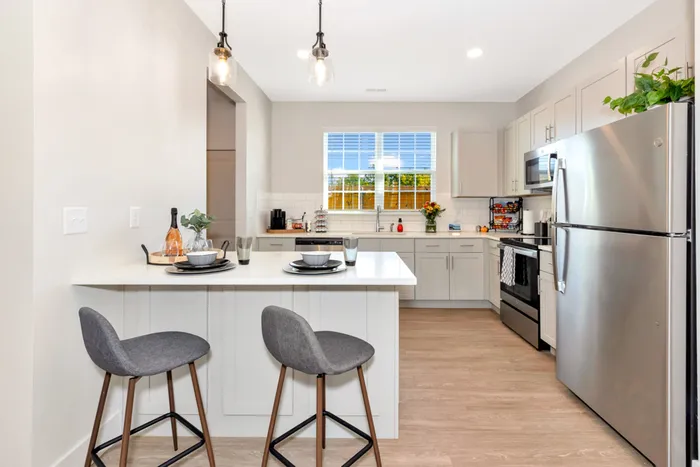 Furnished kitchen with stools and stainless steel appliances located in Huntsville, AL