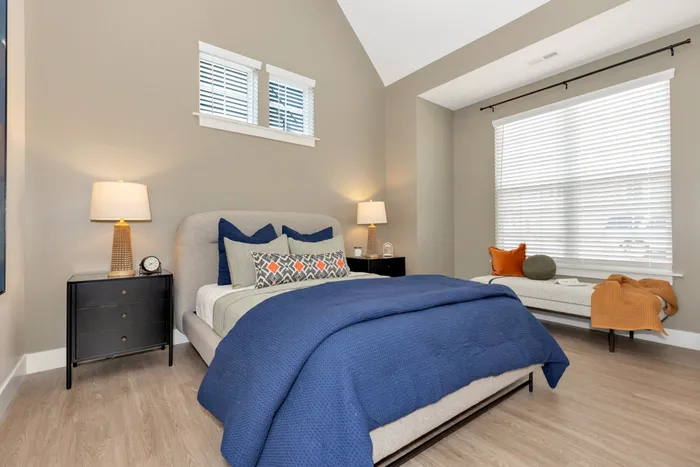 Furnished bedroom with bed and side table
