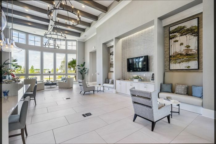 furnished leasing office with seating, desks and television