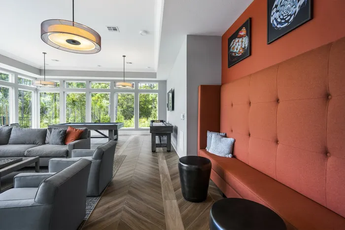 furnished clubroom with booth seating and sofa