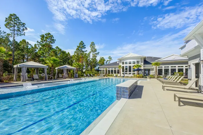 outdoor pool next to clubroom and apartment building in daytime