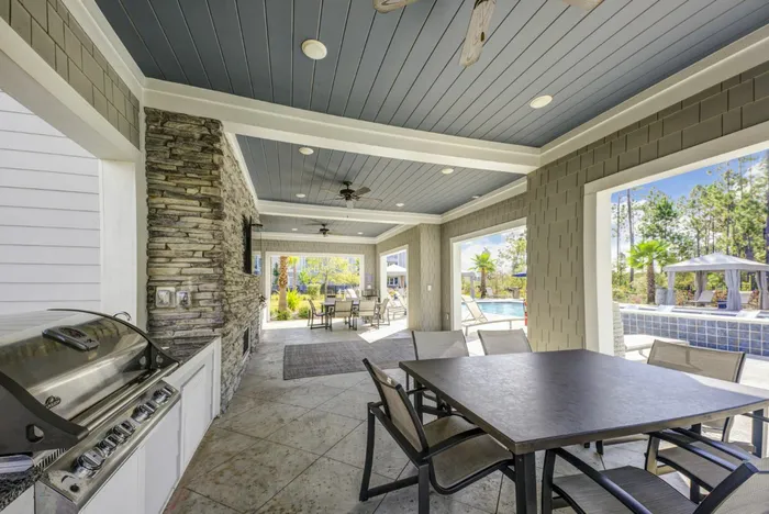 outdoor grilling area with table and chairs in daytime