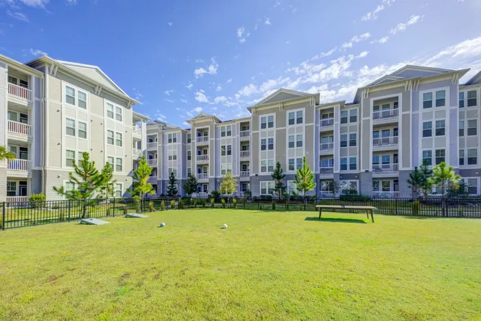 outdoor gaming area on grassy lawn outside of apartment building