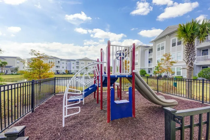 outdoor playground outside of apartment building in daytime
