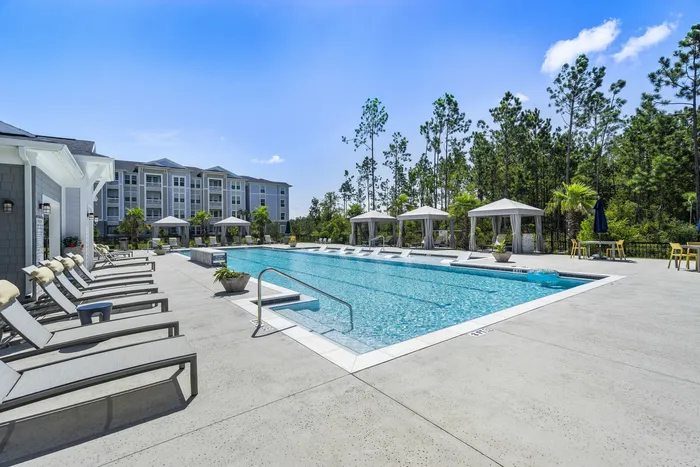 outdoor pool next to clubroom and apartment building in daytime