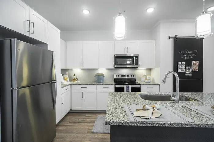 furnished kitchen with island in apartment home