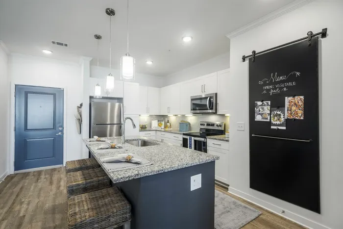 furnished kitchen with island in apartment home