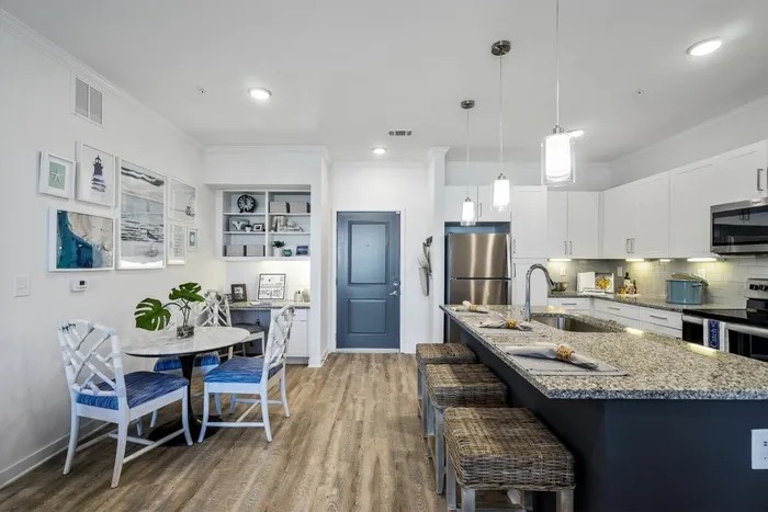 furnished kitchen and dining area with island in apartment home