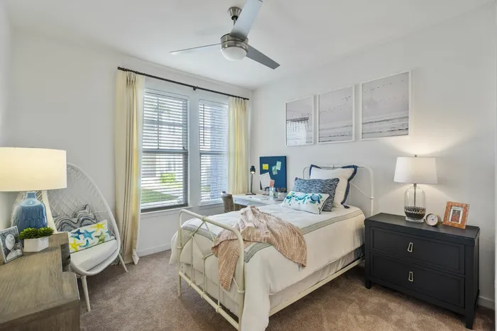 furnished bedroom with bed and window in apartment home