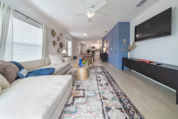 Furnished living room with couch, tv and coffee table