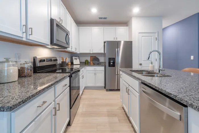 Kitchen with stainless steel applicances and white cabinets