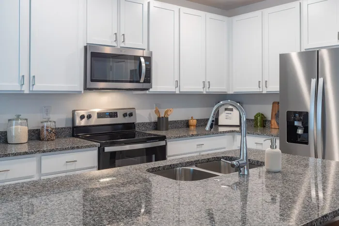Kitchen with stainless steel applicances and white cabinets