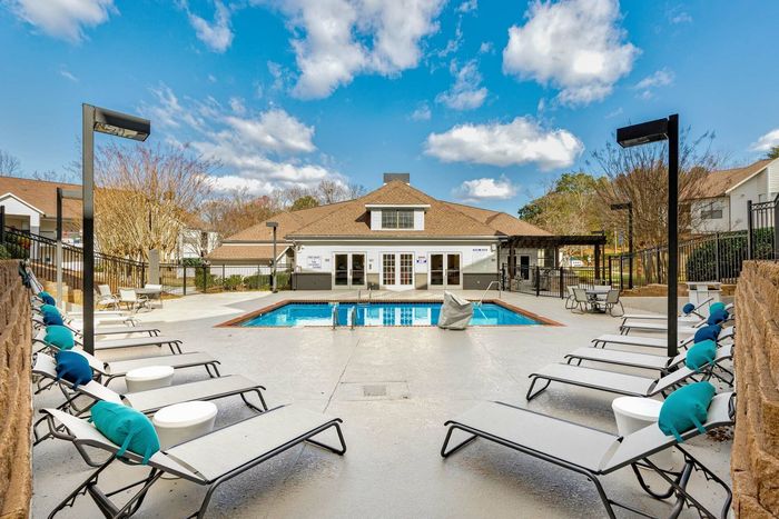 View of the exterior of the pool and leasing office in the day time