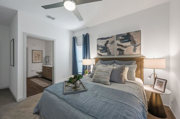 Furnished Bedroom with Carpet looking into bathroom
