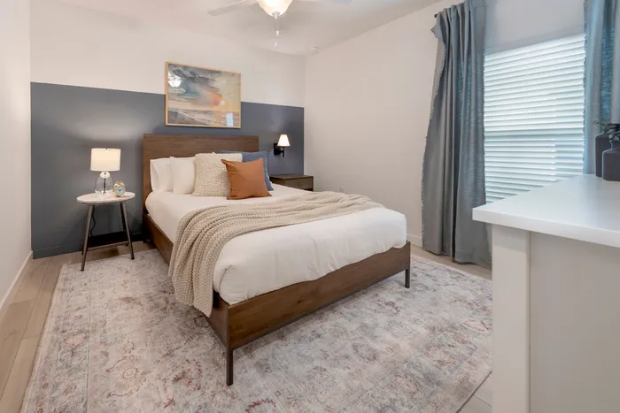 Furnished bedroom with bed and side tables