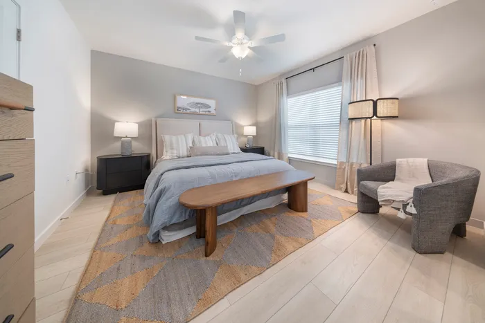 3 BR Homes In Poinciana FL- Preserve At Poinciana - Furnished Bedroom Featuring Ceiling Fan, Large Windows, And Bedside Tables