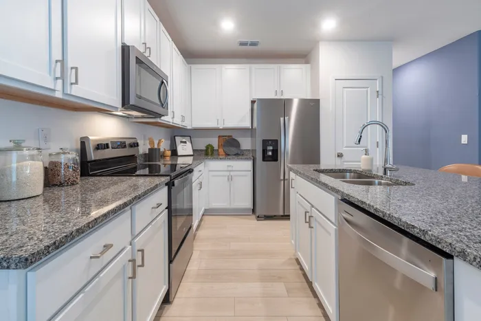 Kitchen with stainless steel applicances and white cabinets