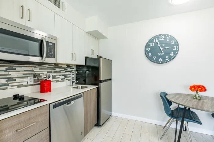 furnished kitchen and dining area of apartment home