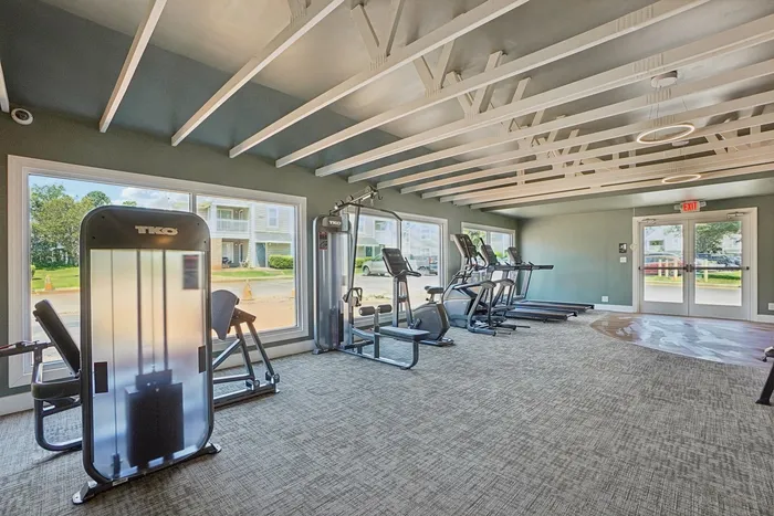 Fitness center with machines and large windows