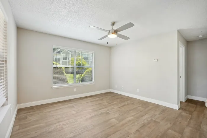 Living room with luxury plank flooring and ceiling fan