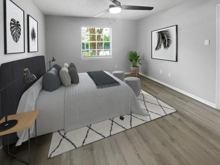 Bedroom with wood style plank flooring, ceiling fan, window
