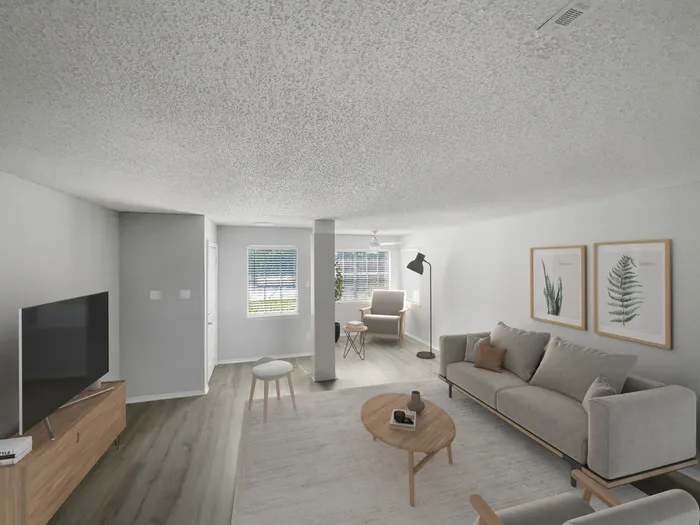 Apartments for Rent in Melbourne, FL - Caribbean Isle - Living Room with a Reading Nook, Wood-Style Floors, and a Circle Coffee Table