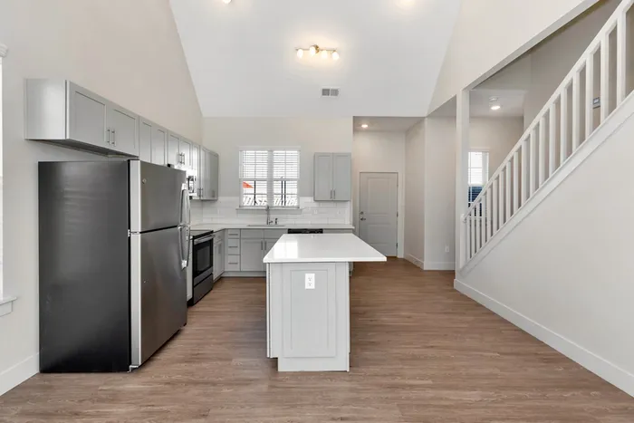 kitchen with tall ceilings next to stairs