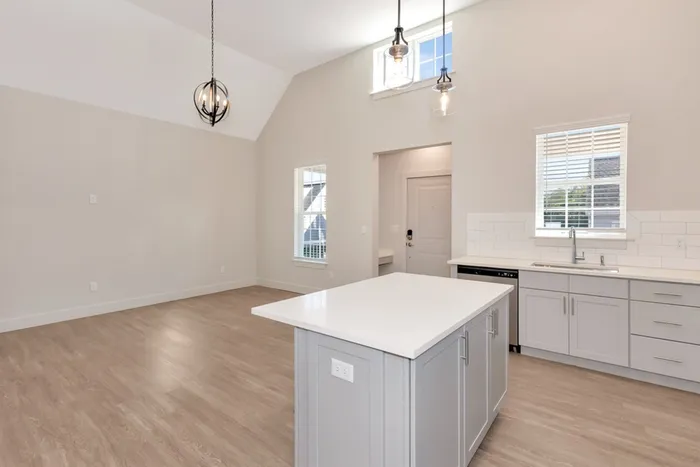 Kitchen with island and vaulted ceilings