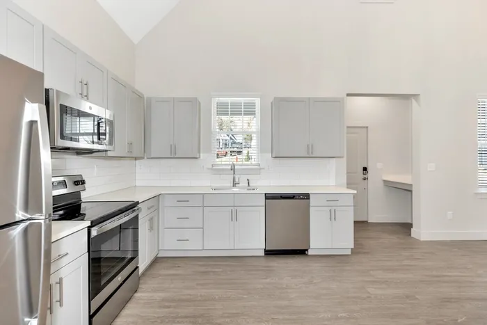 Kitchen with light cabinets and wood style flooring