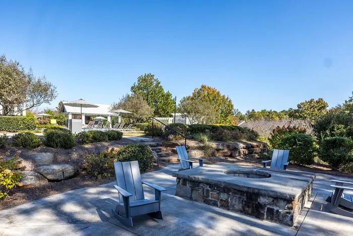 Fire pit with entrance to pool in the back ground