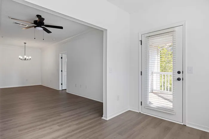 unfurnished living area with ceiling fan and wood style flooring