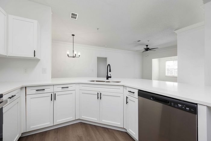 Kitchen with white cabinets and stainless steel and black appliances
