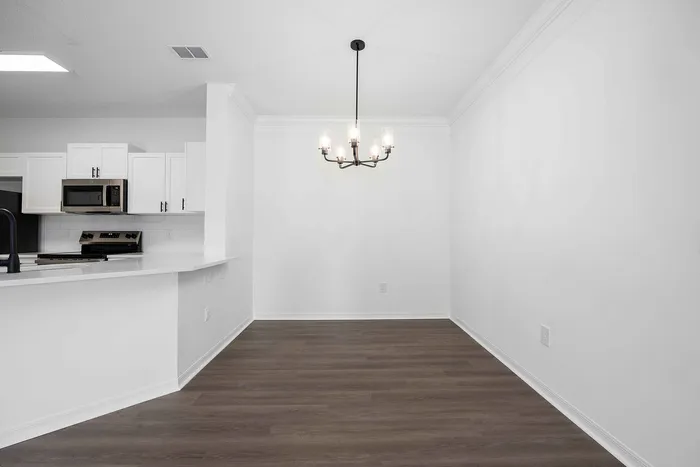 unfurnished dining area with ceiling fan and wood style flooring and window