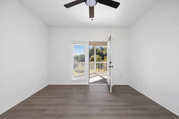 unfurnished living area with ceiling fan and wood style flooring