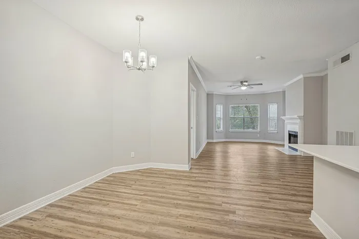 Unfurnished living area with a fire place and woodstyle flooring