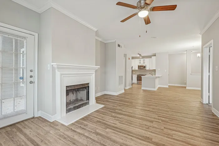 Unfurnished living area with a fire place and woodstyle flooring