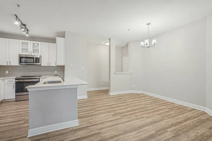 Unfurnished dining area with view of the kitchen with stainless steel appliances