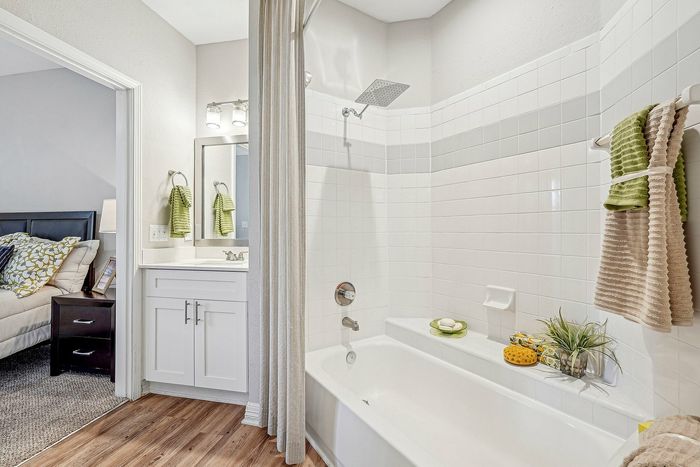 Bathroom with large tub/shower with sink and mirror