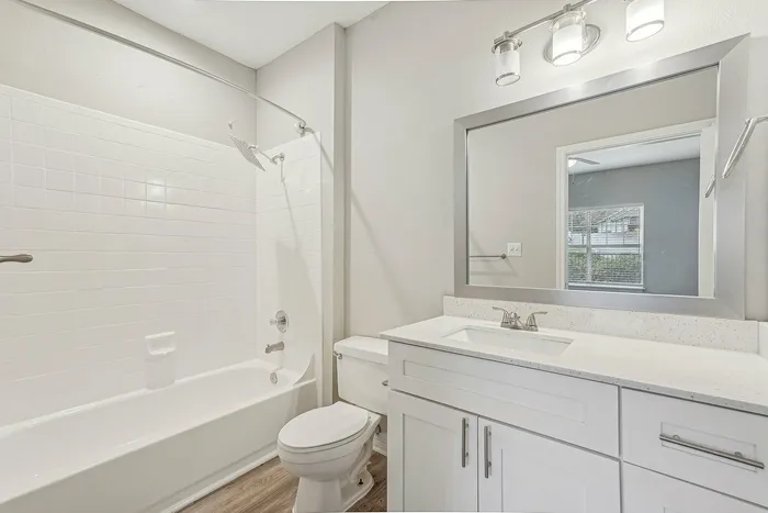 Bathroom with large tub/shower with sink and mirror