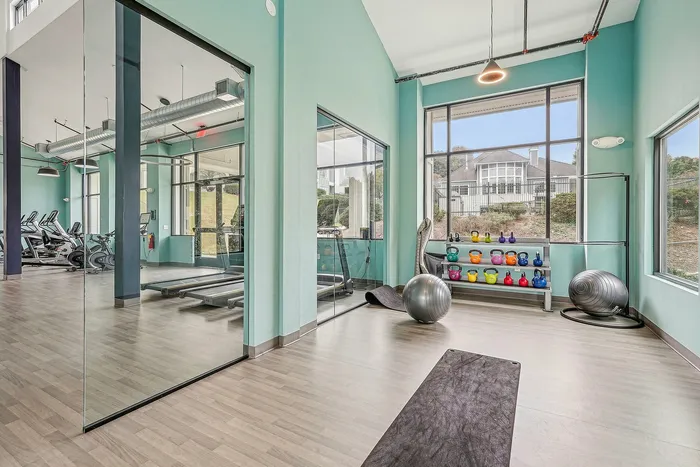 indoor fitness center with mirrors and gym equipment
