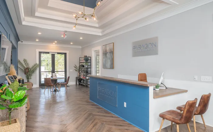 Stylish reception area at Paragon Luxury Apartments with modern decor and elegant lighting.