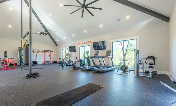 Spacious gym with state-of-the-art exercise equipment and motivational decor