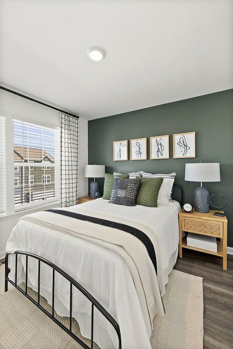 Furnished bedroom with bed and bedside tables and window