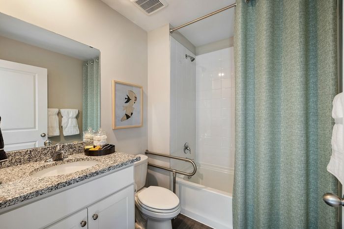 Bathroom with standard tub and sink with mirror above