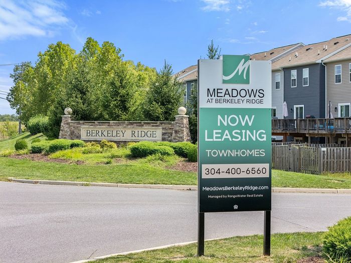 Monument sign with community exteriors in the background